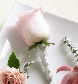 FTD Pink Rose Boutonniere - The FTDÂ® Pink Rose Boutonniere creates the classic picture of wedding   elegance. A single pink rose is chosen for its absolute perfection then   accented with lush greens and a white taffeta ribbon to offer its beauty   and sweet fragrance in honor of the wedding celebration. Approx. 4âH x   2âW.  