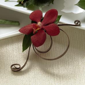 FTD Red Mokara Boutonniere - The FTD Red Mokara Boutonniere is a simply stunning way to bring a   touch of elegance to the men in your wedding party. A single red mokara   orchid bloom is accented with lush greens and embellished with a brown   flat wire to create a fantastic look. Approx. 5â x 3âW. 