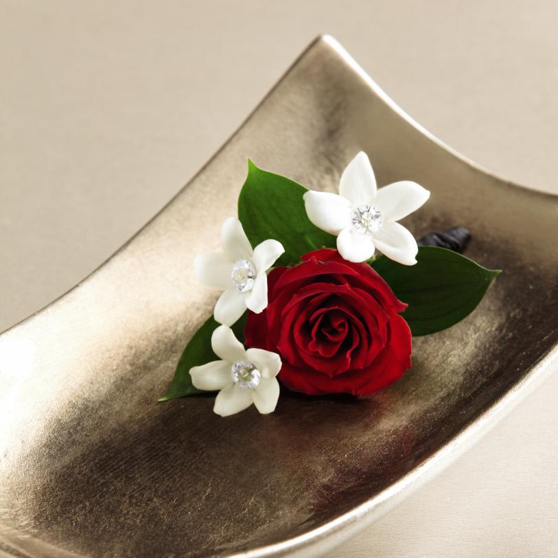  Poetry Boutonniere - ThePoetryâ¢ Boutonniere will be the perfect fit for your wedding  day. A single red rose is accented with white stephanotis blooms donning  sparkling pins at the center to create an exceptional look for the men  standing by you on this most momentous day. Approx. 3âH x 2âW.  