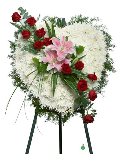 True Heart Standing Spray - Show that your heart is with them – send a gift of hope, beauty and devotion. This lovely standing spray of white blossoms in the shape of a heart is adorned with pink lilies and a dozen fresh red roses.
