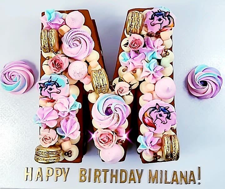 Letter Cake - Celebration Letter Cake - Celebration - Layered cake topped with your favorite treats and designs. Working with a theme? Let us know and we can customize the colors and toppings to your event. FYI: Photos shown represent the overall theme and style of the cake for illustrations purposes only. Please contact us for your design ideas and customization.