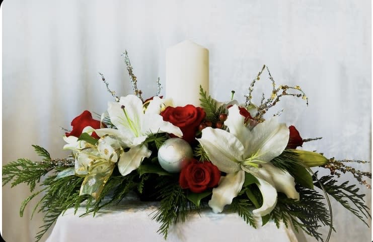Garden of Grandeur by Cactus flowers by Tania - The signature colors of Christmas are on display in our grand holiday centerpiece with an abundance of red &amp; white blooms, lush greenery and glistening, and white candle it’s the perfect gift for celebrating the season in luxurious style.