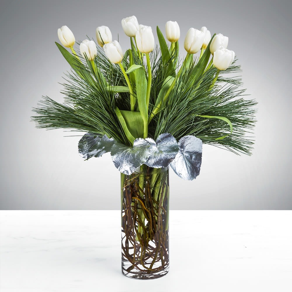 Tranquil Tulip By BloomNation™ Tranquil Tulip By BloomNation™ - People spend lifetimes searching for inner peace. We’re not going to say the Tranquil Tulip arrangement will lead you immediately there. But, on the other hand, who wouldn’t want a bit of tulip comfort on their meandering path to lifelong serenity. Gift this arrangement to someone who deserves a bit of tranquility in their life this holiday season.