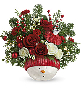 WINTER FUN ORNAMENT - This jolly snowman can't wait to bring his fresh, festive bouquet to your holiday celebrations! He's ready for years of Christmas fun thanks to his sturdy ceramic design and gorgeous glazed finish.  Red roses, white spray roses, miniature red carnations, and white waxflower are accented with noble fir and cedar. Delivered in Teleflora's Snowman Ornament. Approximately 13 1/2&quot; W x 12 1/2&quot; H