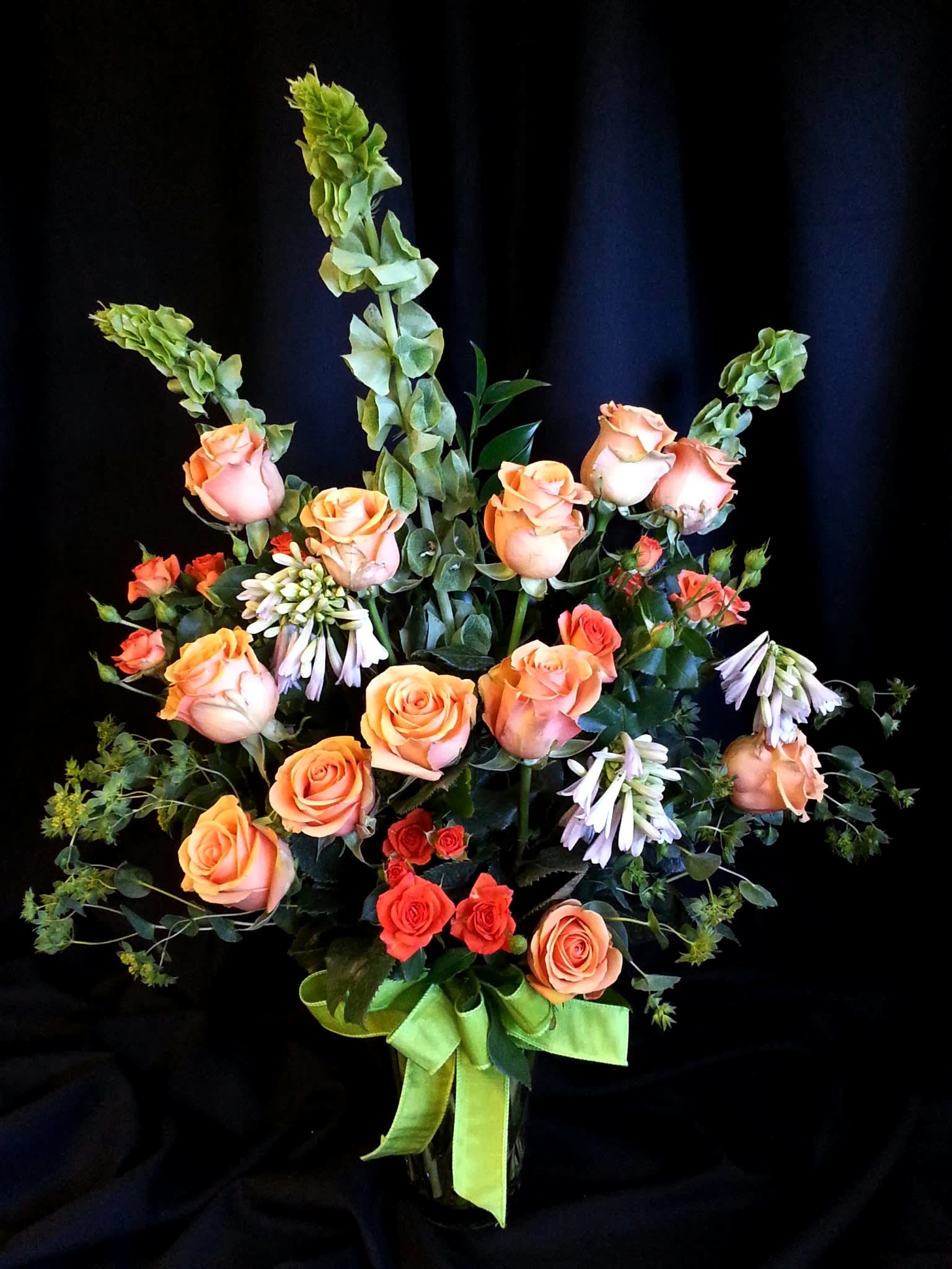 Roses, spray roses, bells and ivory coast Roses, spray roses, bells and ivory coast - Assortment of romantic flowers in complimenting colors. Color and accent flowers may vary. Lovely for Valentine's day, an engagement or proposal dinner, or any cherished moment. Order in advance for specific colors.
