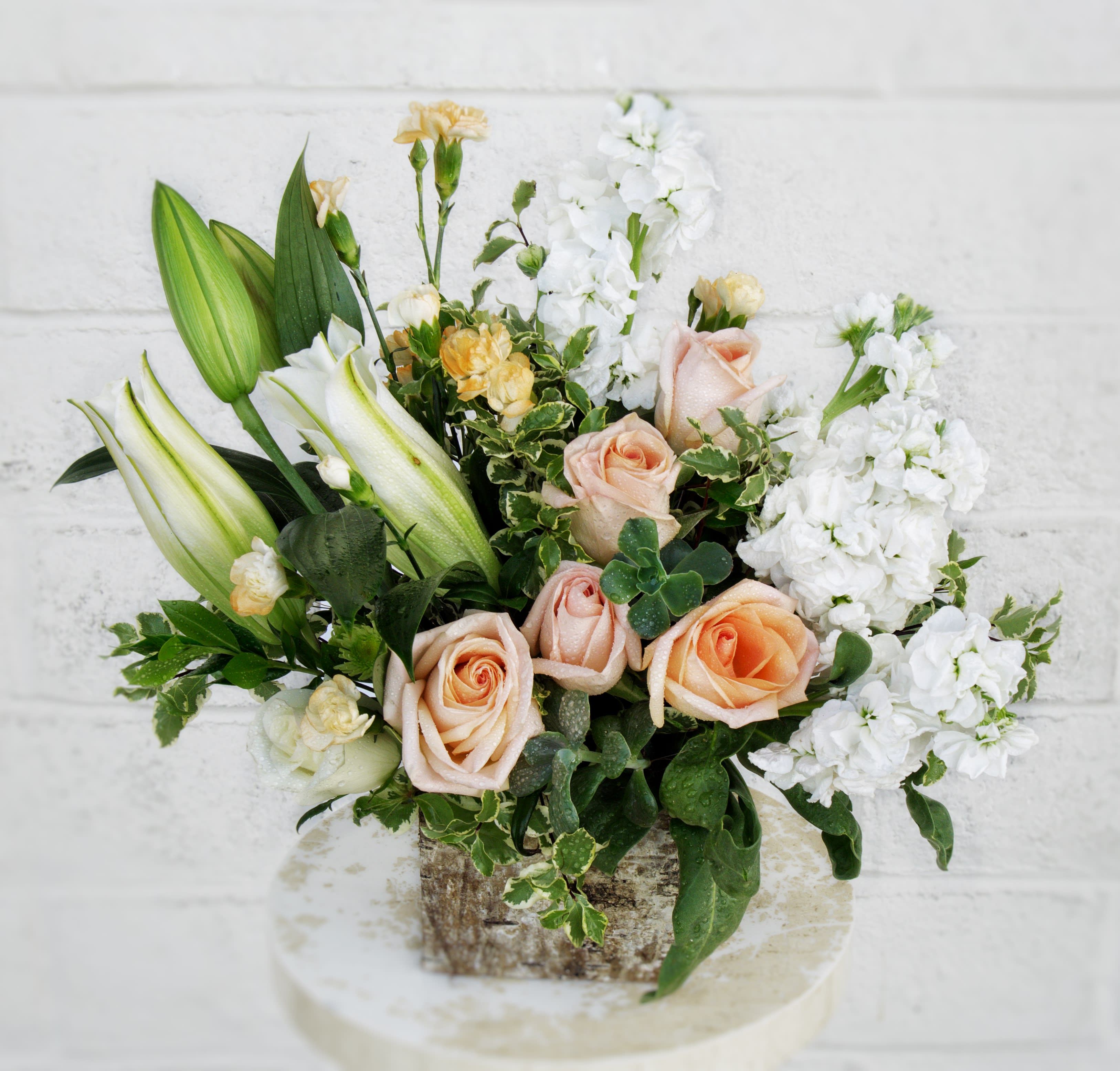 Blooming Desert - Fresh design including lily, rose, fragrant stock, succulent and accents in a glass cube.