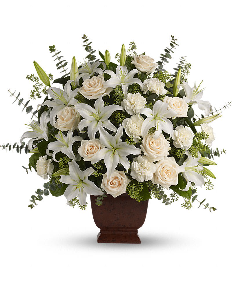 Teleflora's Loving Lilies and Roses Bouquet - A simply beautiful way to show you care. By sending this elegant arrangement to the home of those in mourning you are letting them know they are embraced in your thoughts. And in your heart. Fresh flowers such as crÃ¨me roses white oriental lilies carnations eucalyptus and more are delivered in a lovely Noble Heritage urn.