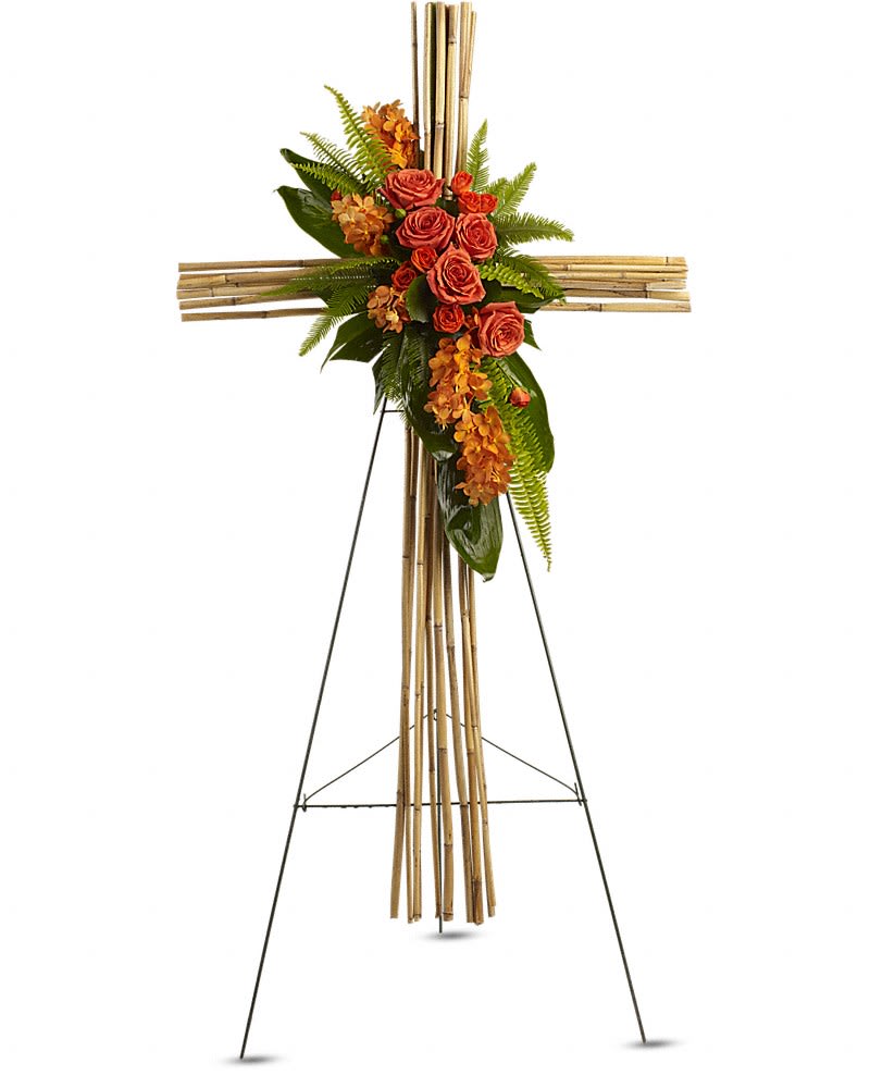River Cane Cross - Acknowledging deep devotion this unique cross is a simply stunning way to honor the deceased while delivering a message of faith and hope to the mourning. A natural river cane cross is adorned with a brilliant display of flowers and greenery such as orange mokara orchids roses and spray roses green ti leaves umbrella and sword fern and galax leaves all in an arrangement that is as exceptional as it is beautiful.