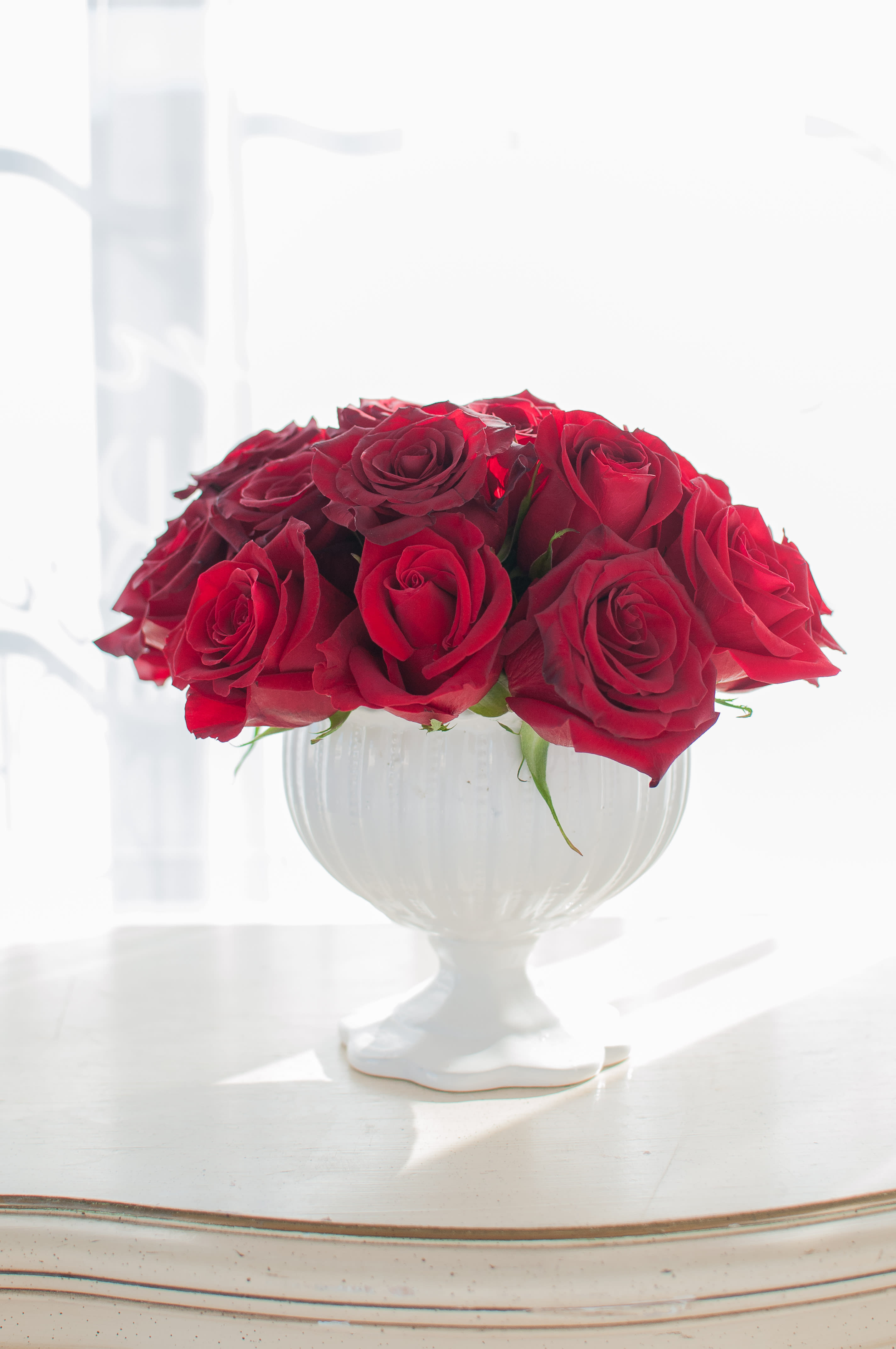 Red Rose Pedestal - We just love this chic pedestal arrangement filled with red roses! So simple, but yet so elegant! There are approx 20 roses in this arrangement.  (Photo Credit: Simpson Portraits)