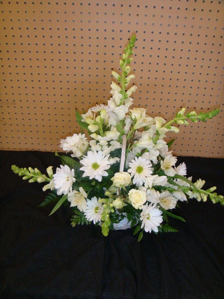 SYA14 Sympathy Arrangement  Whites - Sympathy Arrangement of Spray Roses, Daisies,Snap Dragons &amp; alstros In A White Wicker Basket With Assorted Greenery 