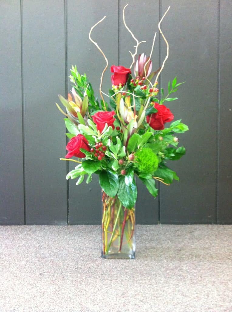 Safari Roses - 4 red roses beautifully arranged with safari sunset, coffee bean, dianthus and curly willow. Perfect for any occasion!  (Photo Credit: Simpson Portraits)