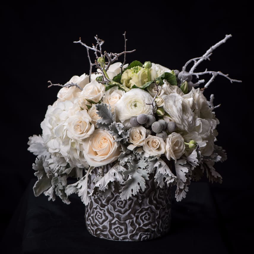 Let It Snow Let It Snow - A holiday arrangement composed of hydrangeas, spray roses, white roses, ranunculus, flocked branches.
