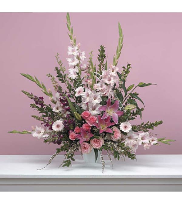Traditional Pink arrangement Traditional Pink arrangement - This is a traditional all pink arrangement filled with an array of all shades of pink & raspberry colors. This is a elegant tribute for any funeral or an memorial service.. This arrangement has gladiolus, larkspur, snapdragons, lillies, roses, carnations, gerbera daisy and an array of seasonal flowers. Product ID SF 55-21
