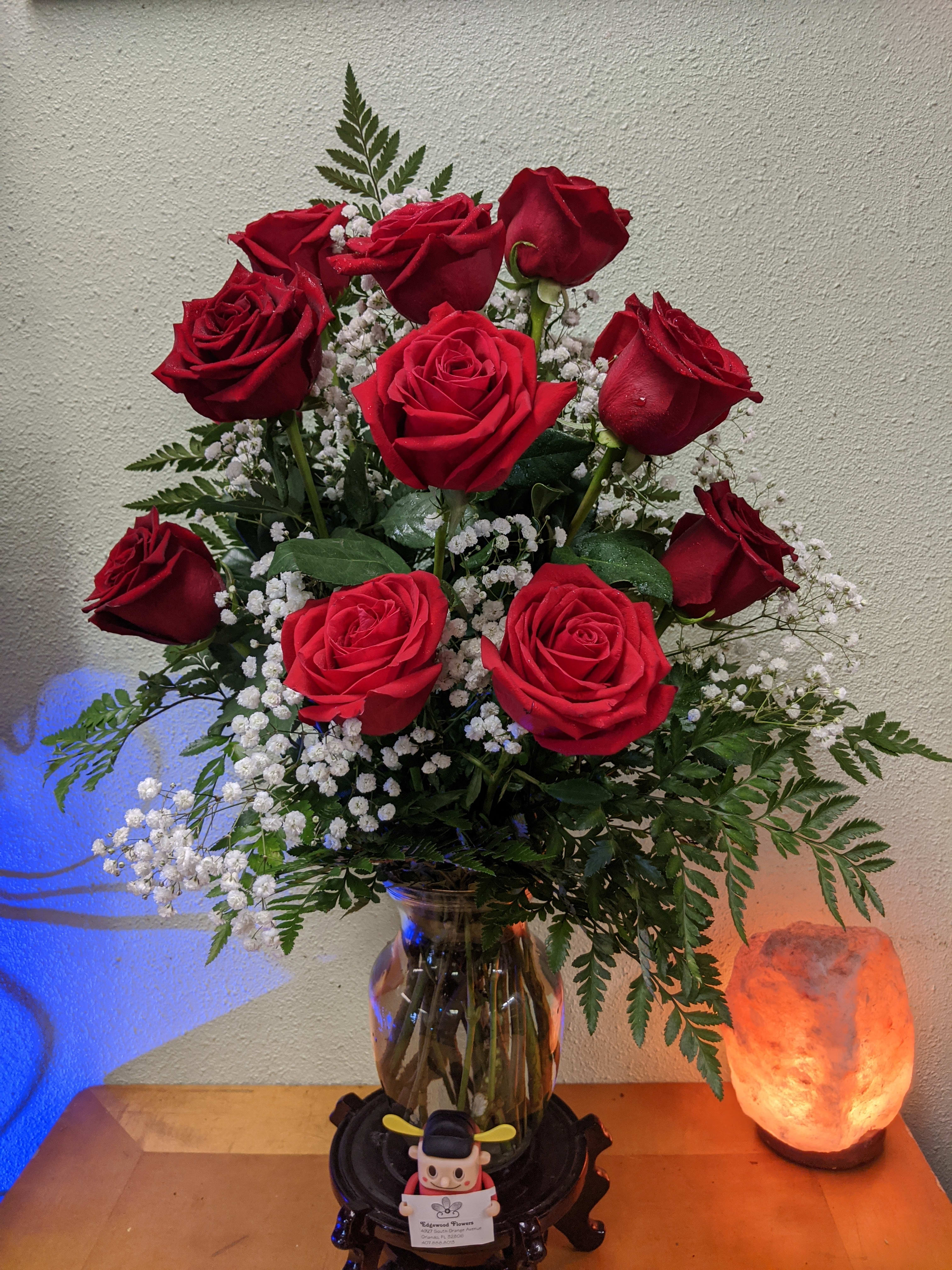 The Red Rose Bouquet - The Red Rose Bouquet offers a symbol of lasting love and undying affection in this time of grief and loss. Rich red roses are perfectly arranged with seeded eucalyptus in a classic clear glass vase to create a bouquet that expresses your most heartfelt sympathies.