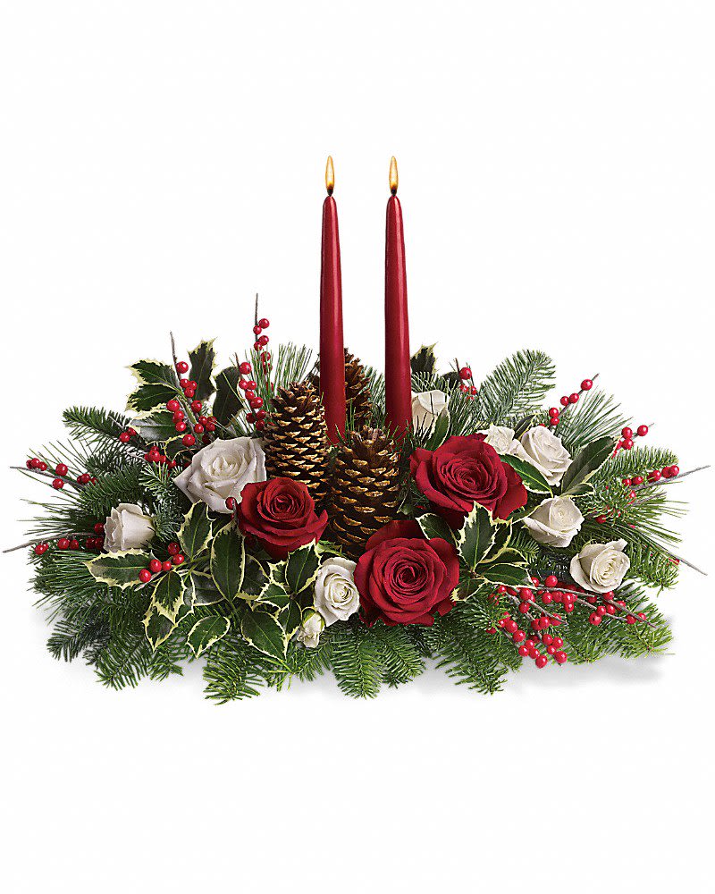 Christmas Wishes Centerpiece - Elegant. Lovely. Radiant. This beautiful Christmas centerpiece is everything you could wish for and more. Stunning red and white roses, white spray roses and chrysanthemums plus all of your holiday favorites like pinecones, berries, holly, Christmas greenery and two tall-tapered candles. A brilliant way to send your Christmas wishes in style.