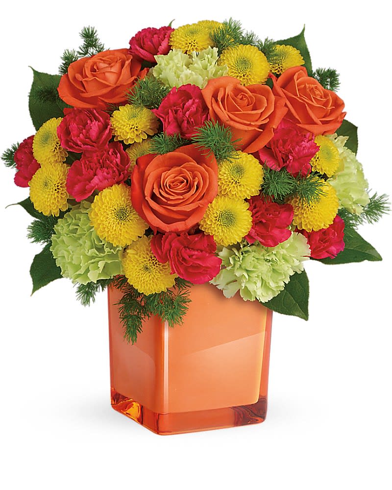 Teleflora's Citrus Smiles Bouquet - They brighten your days with their friendship and love, brighten theirs with these bold and beautiful blooms! Hand-delivered in a stylish glass cube, a gift in and of itself - this spirited mix of roses, carnations and mums is sure to make them smile! Bold orange roses, green carnations, dark pink miniature carnations, and yellow button spray chrysanthemums are mixed with ming fern and lemon leaf. Delivered in a glass cube.