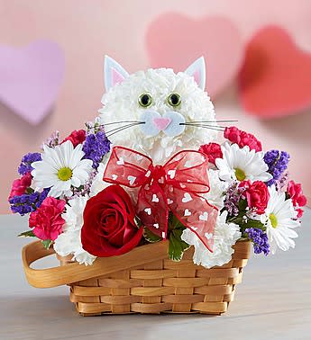 Flirty Feline -  We’ve created the purr-fect surprise for someone special! Handcrafted from fresh white carnations, our cute cat arrives in a charming basket filled with a mix of hot pink mini carnations, white daisy poms and more. Holding a single romantic red rose and finished off with a sweet bow, our truly original kitten is sure to have everyone smitten!
