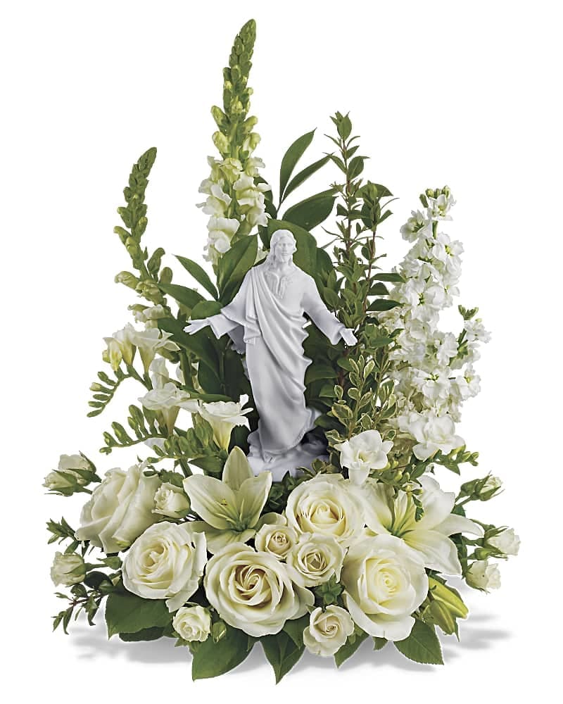 Teleflora's Garden of Serenity Bouquet - This exquisite porcelain sculpture of Jesus surrounded by radiant flowers will be a source of comfort to loved ones during a time of loss. Your thoughtfulness will be long remembered. The stunning bouquet includes white roses, stock, snapdragons, lilies and freesia accented with salal, myrtle and pittosporum. Delivered with a meticulously detailed porcelain sculpture of Jesus.