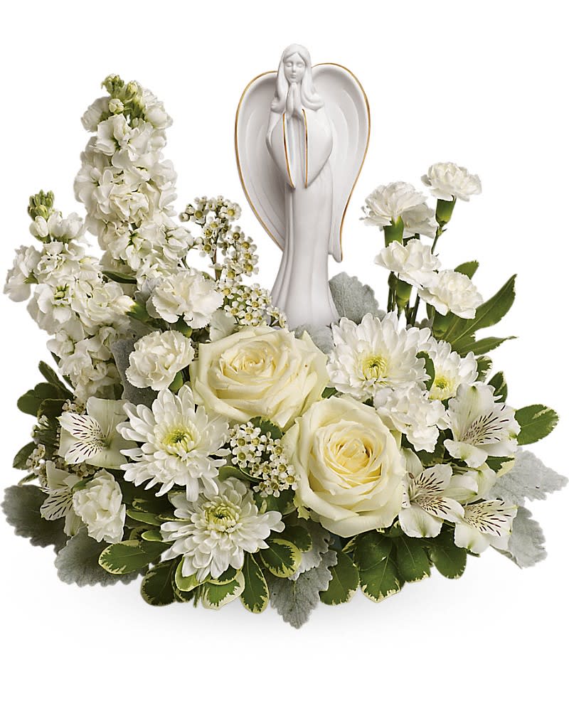 Teleflora's Guiding Light Bouquet - Peaceful and majestic, a graceful angel rests amongst fragrant, snow white roses, alstroemeria and stock - a touching tribute to a bright life and your unending support. White roses, white alstroemeria, white stock, white miniature carnations, white cushion spray chrysanthemums are arranged with white waxflower, dusty miller and variegated pittosporum. Delivered with an Angel of Grace keepsake.