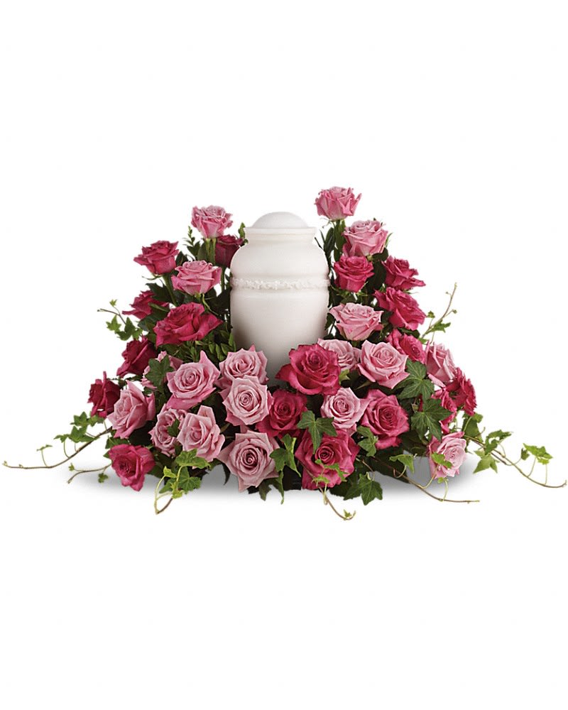 Bed of Pink Roses - A loving embrace. A beautiful gesture. A respectful tribute. A wealth of pink roses create a soft, serene and dignified way to cherish and honor the departed. An awesome display of pink roses are lovingly arranged with ivy and other gentle greens to display the urn.Please note: Arrangement does not include urn.