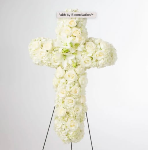 Faith by You - An all white tribute, this white cross funeral spray is pure and tranquil. Featuring a variety of white flowers, this elegant easel compliments the beauty of life. 