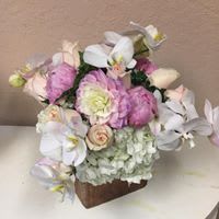 Blushing Pinks and Whites  - A stunning cube vase with a lush texture of hydrangea, roses, lisianthus, dahlias with flowing white orchids. 