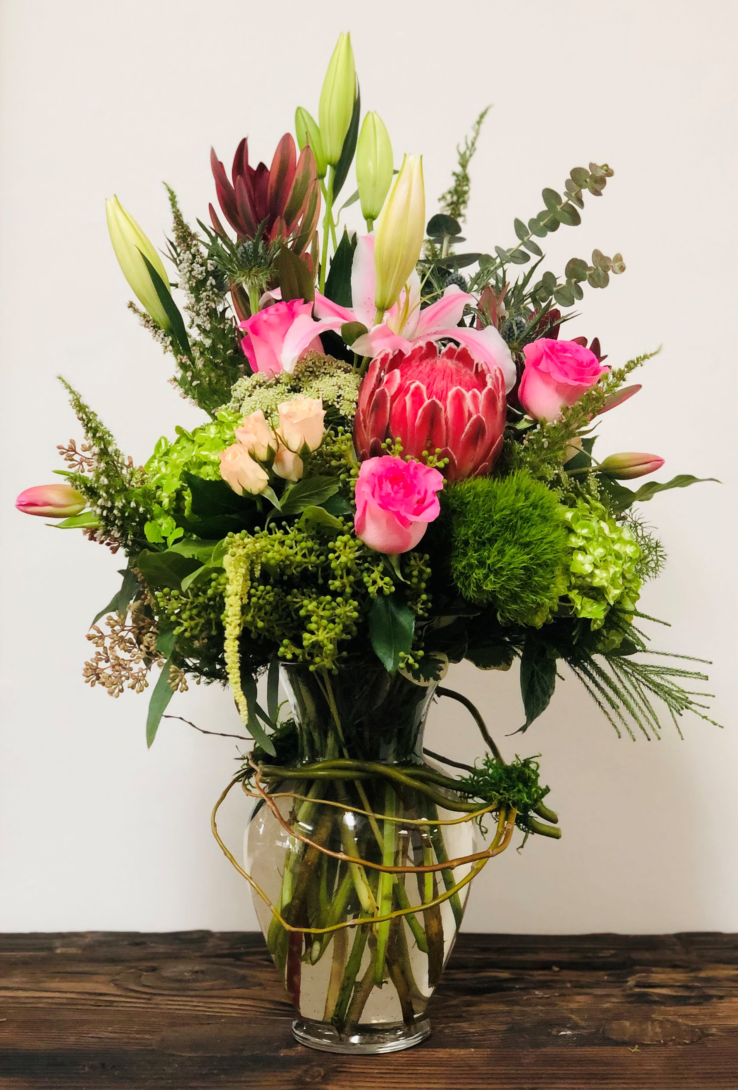 Pretty 'N Pink - This beautiful arrangement is the perfect gift for any occasion. It's full of hand selected hydrangeas, star gazers lilies, roses, spray roses, tulips, thistle, and beautiful fillers perfectly styled in a large glass garden vase.