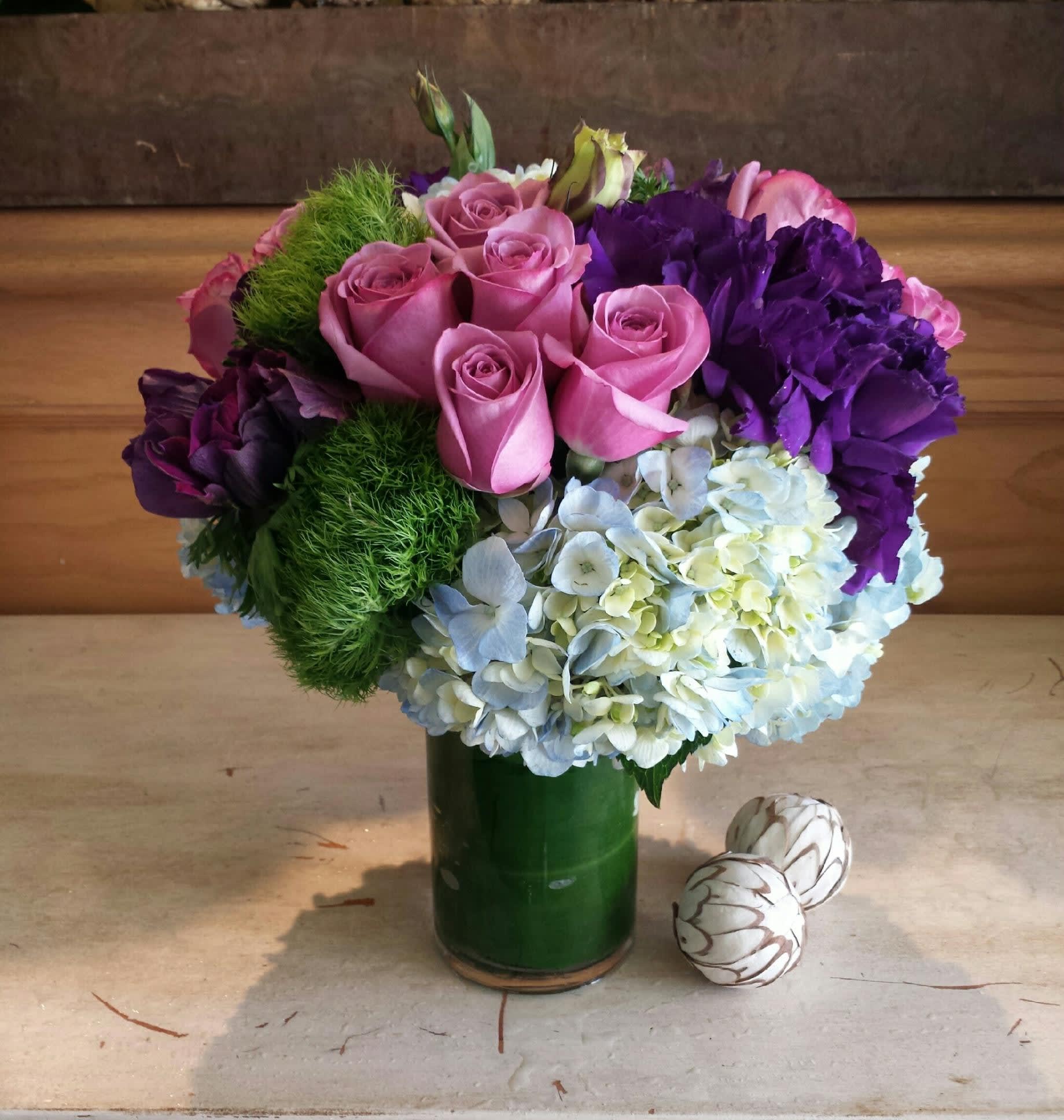 Ocean Dream - Lavender, purple, and pale blue in cool and refreshing colors with complementing greenery.  Arranged in a lovely all around design.