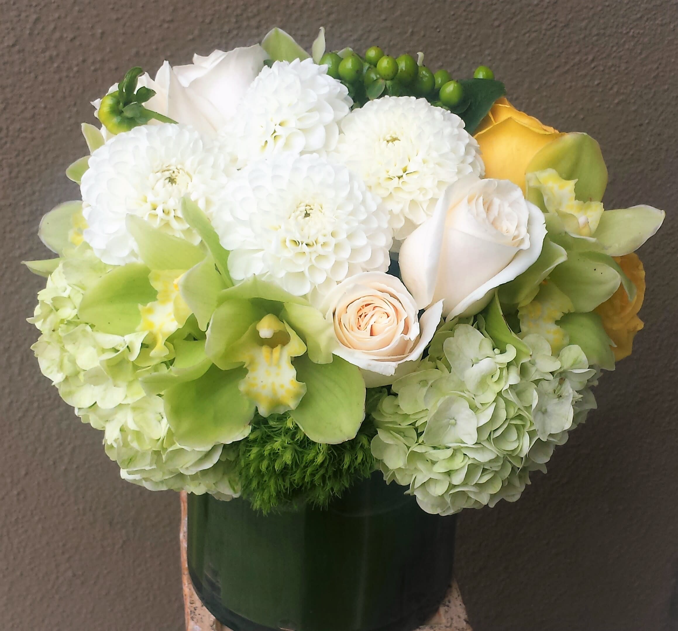 Lemonade - Clean and elegant low square arrangement in green, white and a touch of yellow blooms.
