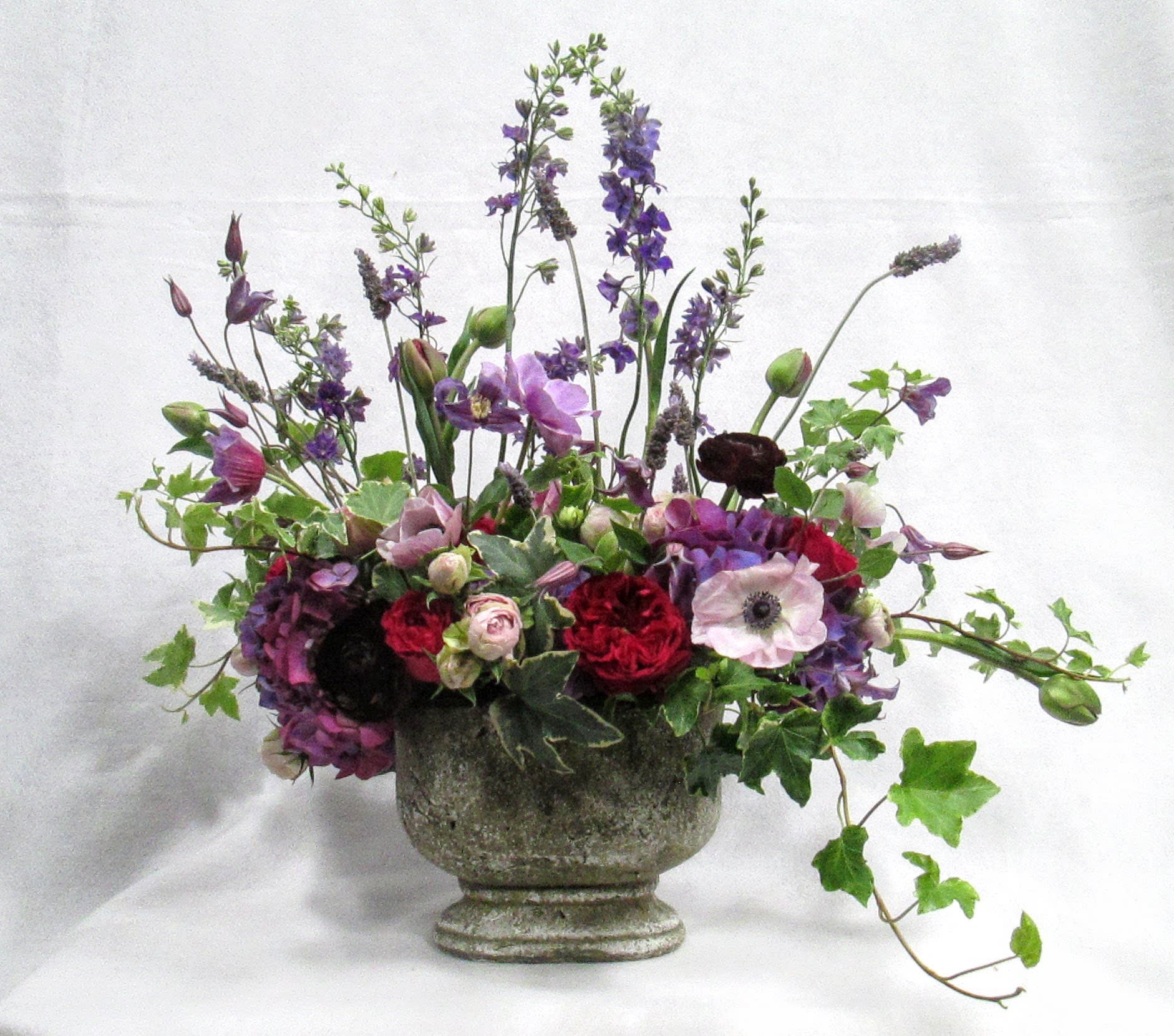 Purple English Garden Purple English Garden - Garden style pedestal vase filled with the Season's best in purple and green.