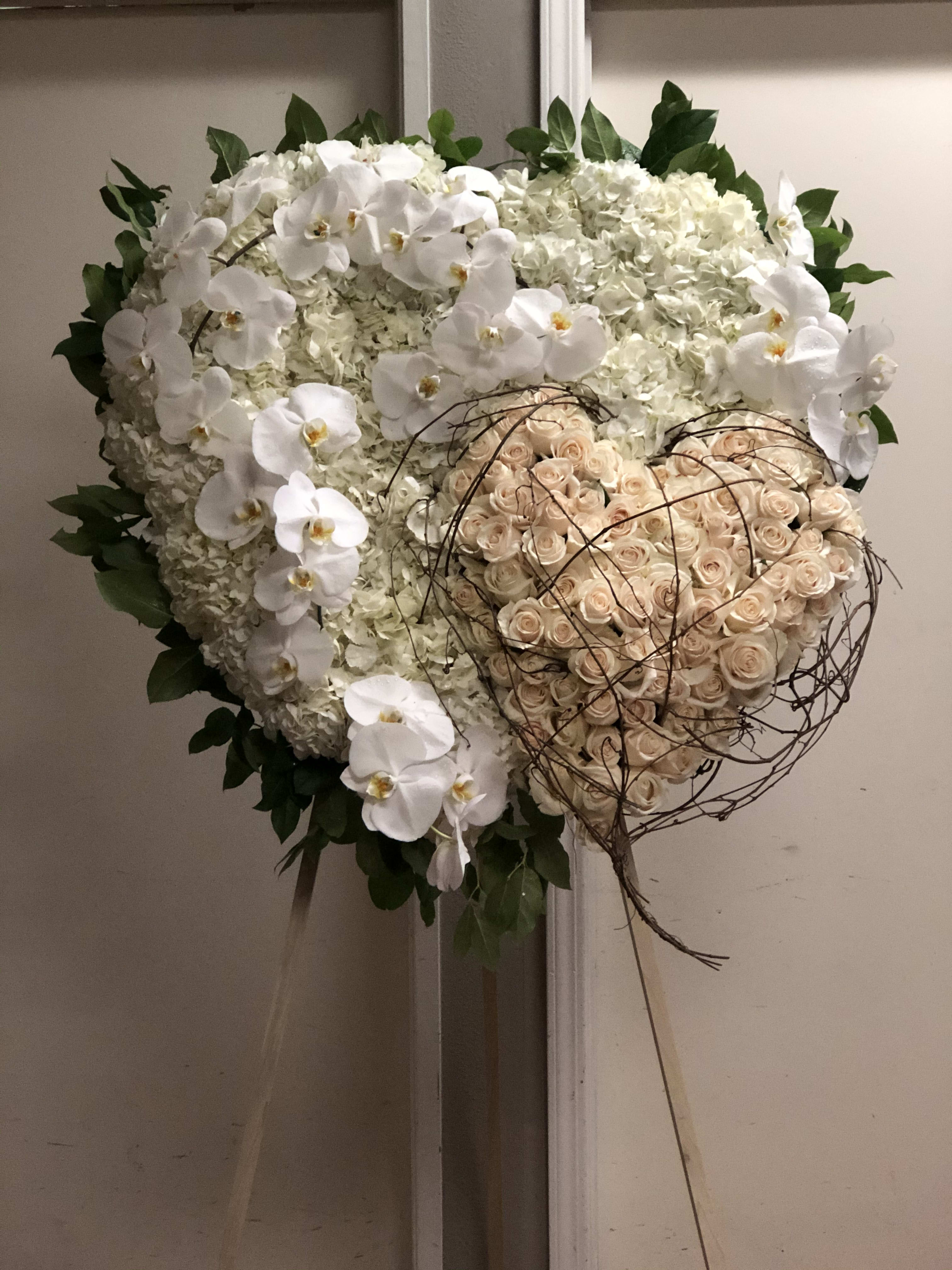 White Hearts White Hearts - Two Hearts arranged together on one stand. Original funeral pice made with care and lots of love. This arrangement is special and memorable.