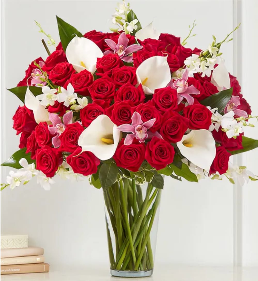Elegant Extravagance - The ultimate Valentine’s WOW gift! Our extravagant arrangement towers over two feet tall, featuring a gathering of roses, orchids and calla lilies in striking shades of red, pink and white. Accented by lush and textural greenery, it’s artistically designed in a clear glass vase to let the beauty of each bloom stand out. When it comes to surprising the one you love, this is truly the most unforgettable gift you can send.