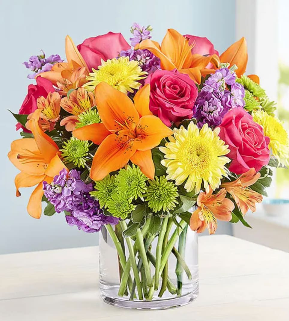 Vibrant Beauty™ Bouquet - A gift to match their vibrant personality. Our must-send bouquet is designed with a bold gathering of blooms—yellow, hot pink, orange and purple—bringing lots of beauty and brightness to the big, small and in-between moments.