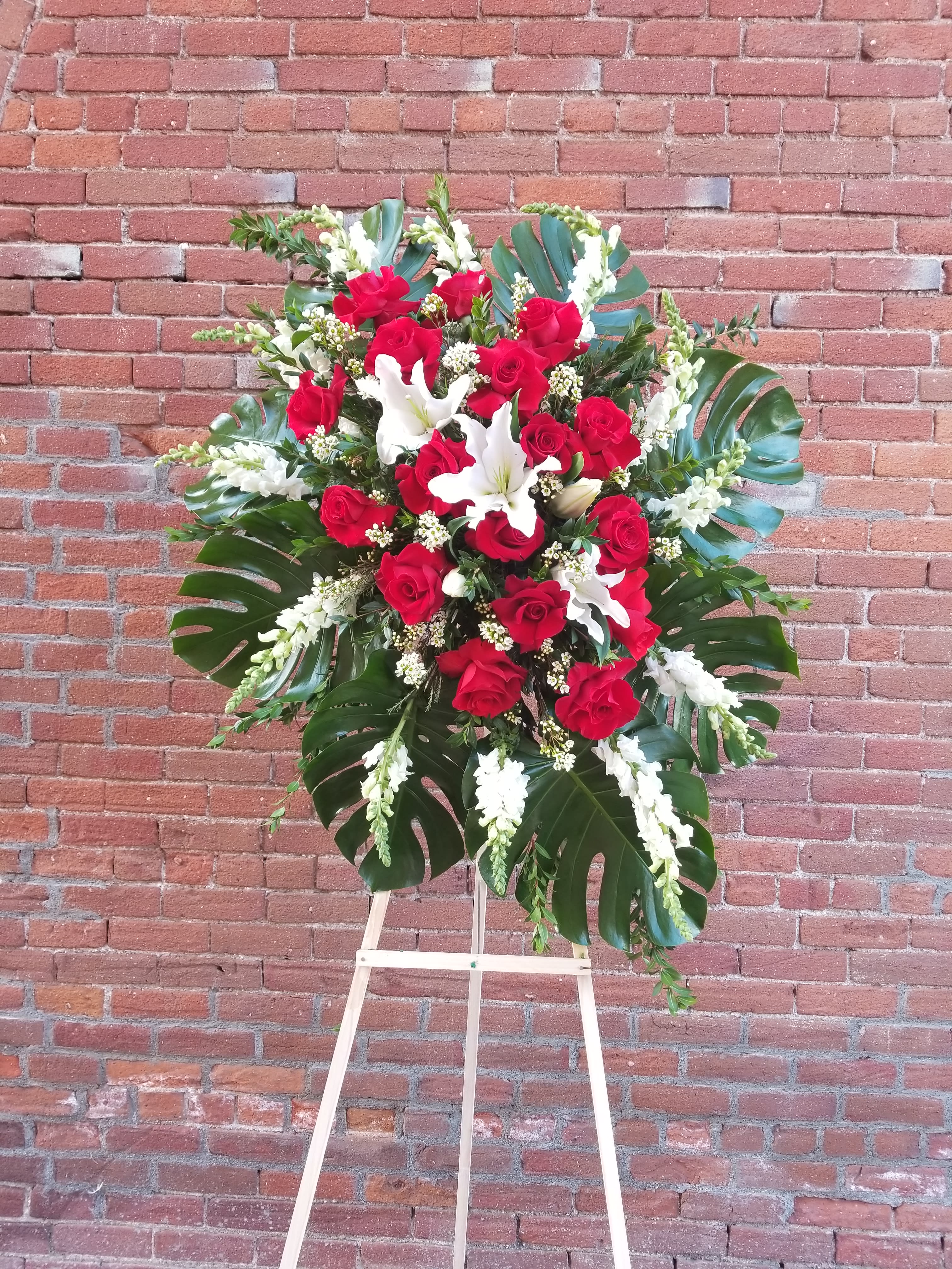 Peaceful Remembrance Peaceful Remembrance - Composed of Roses, Lilies, Snapdragons, Monster Leaves, Fillers. Stand included.