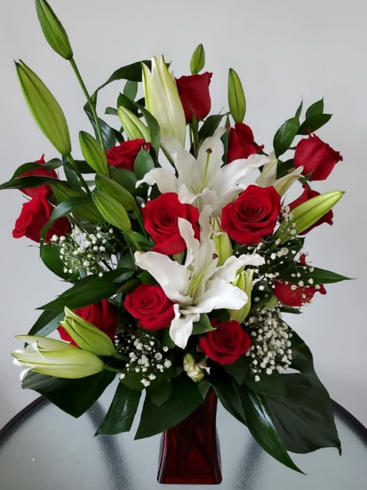 In Love With You - There's nothing like the combination of red roses with white lilies to demonstrate the passion and adoration you feel for that special someone.  Flowers and similar colors