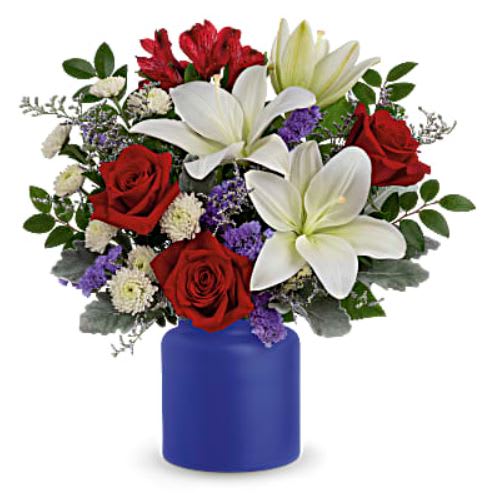 Rose Revelry Bouquet - Revel in the crisp, classic color scheme of pristine white lilies and radiant red roses, presented in a cobalt-hued, frosted glass jar. White asiatic lilies, red roses, red alstroemeria, white button spray chrysanthemums, purple sinuata statice and misty blue limonium are accented with dusty miller and huckleberry. Delivered in Teleflora's Savannah Jar.
