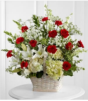 The FTD® In Loving Memory™ Arrangement - The FTD® In Loving Memory™ Arrangement pays tribute to a life well-lived with every beautiful bloom. Red roses and carnations pop amongst this incredible arrangement of white hydrangea, Oriental lilies, snapdragons, larkspur, Queen Anne's Lace and assorted lush greens, lovingly arranged in a large whitewash rectangular basket to create an impressive display of caring kindness. GOOD basket includes 29 stems. Approximately 28&quot;H x 28&quot;W. Your purchase includes a complimentary personalized gift message.