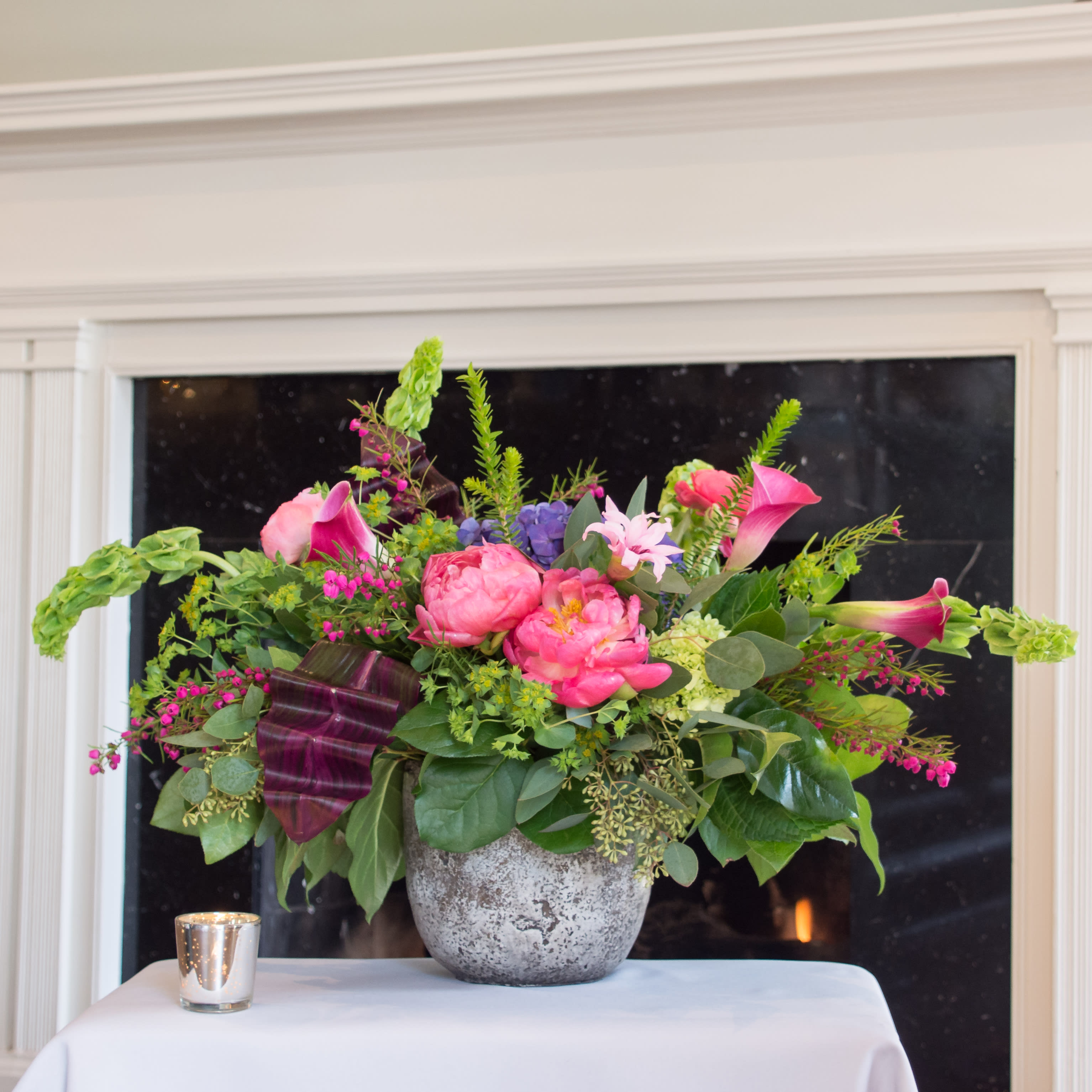 Shelldons Delight - An amazing assortment of beautiful blooms emcompassed in pinks, purples and lush foliage. Designed in a beautiful concrete style container