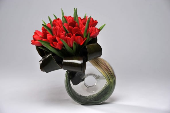 Lover French Tulips Lover French Tulips - 20 Beautiful stems of French Tulips hand tied with deep leaves are presented in this signature vase accented with grass. Tulips are available White, Pink and Yellow depending on availability vase style may vary. RED TULIPS ARE NOW SOLD OUT!!!!