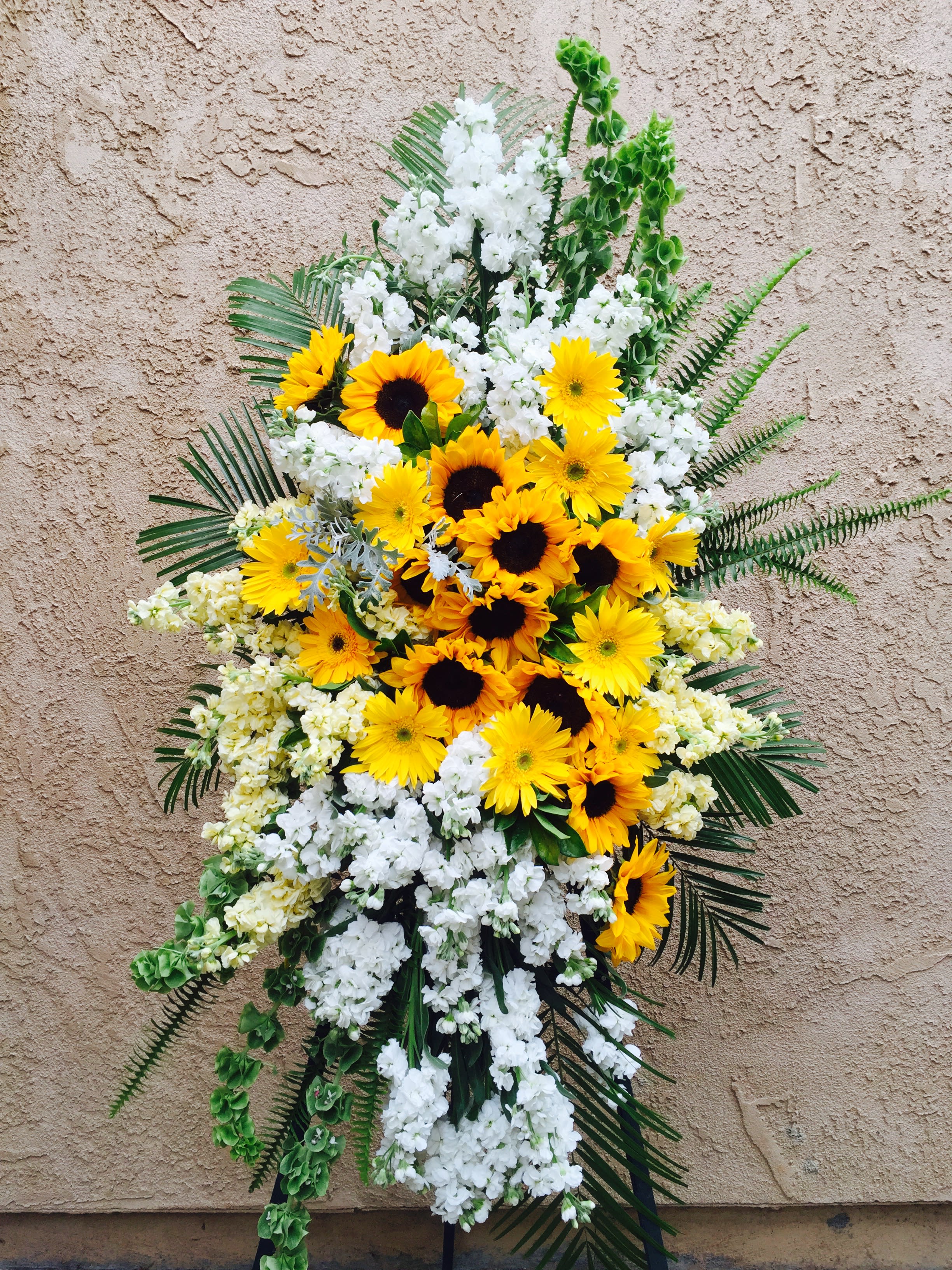 Funeral Spray 17 - funeral standing spray with white and yellow flowers.