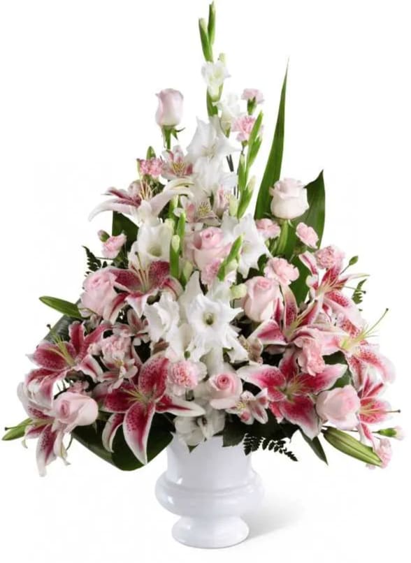 Precious Peace - Precious Peace Arrangement is an exquisite display of serene wishes and grace. Soft pink roses, Peruvian lilies and mini carnations are arranged amongst dazzling Stargazer lilies and white gladiolus, gorgeously accented with lush greens. Perfectly situated in a white plastic designer urn, this stunning arrangement will add to the beauty and elegance of their service or memorial.
