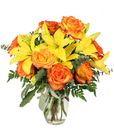 Amber Explosion - A show-stopping arrangement of lilies and roses in vivacious shades of yellow and orange.