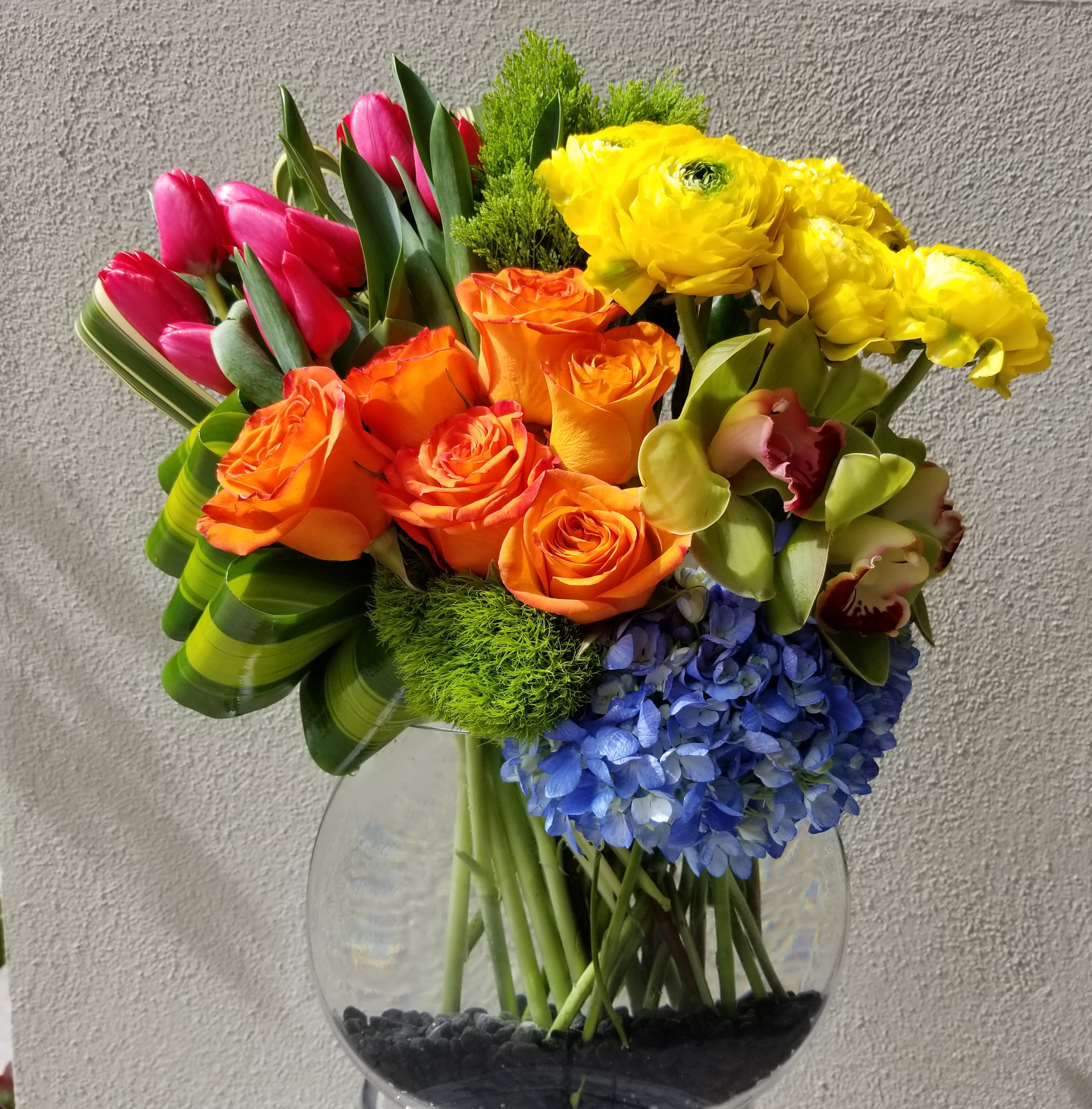 Radiant - Flat bowl composed of bright vibrant blooms such as hydrangeas, roses, ranunculus, tulips and orchids.