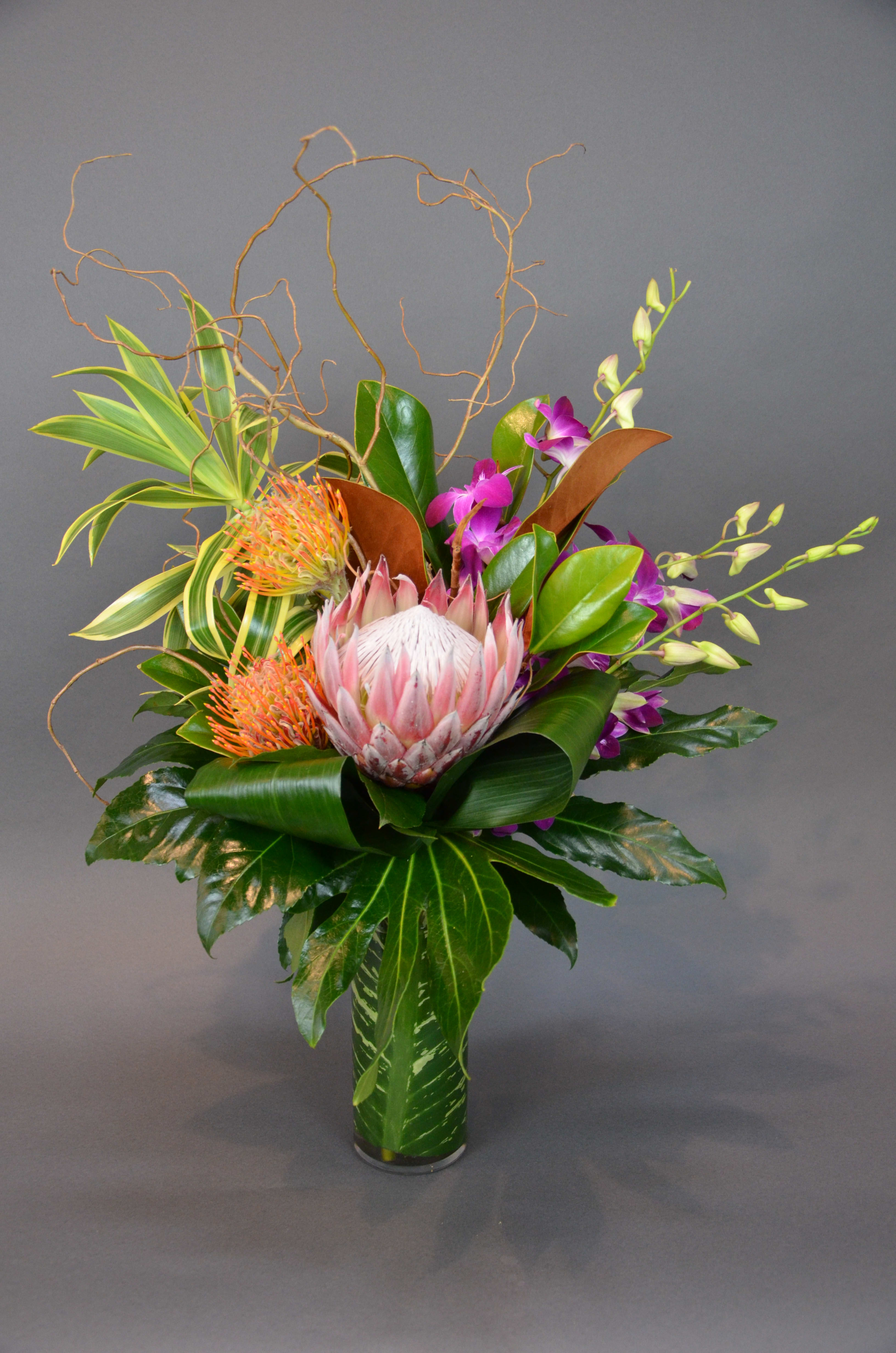Tropical Flair - A seasonal assortment of beautiful tropical blooms. The flower selection may vary, due to seasonal availability. but will always be a tropical breeze. 