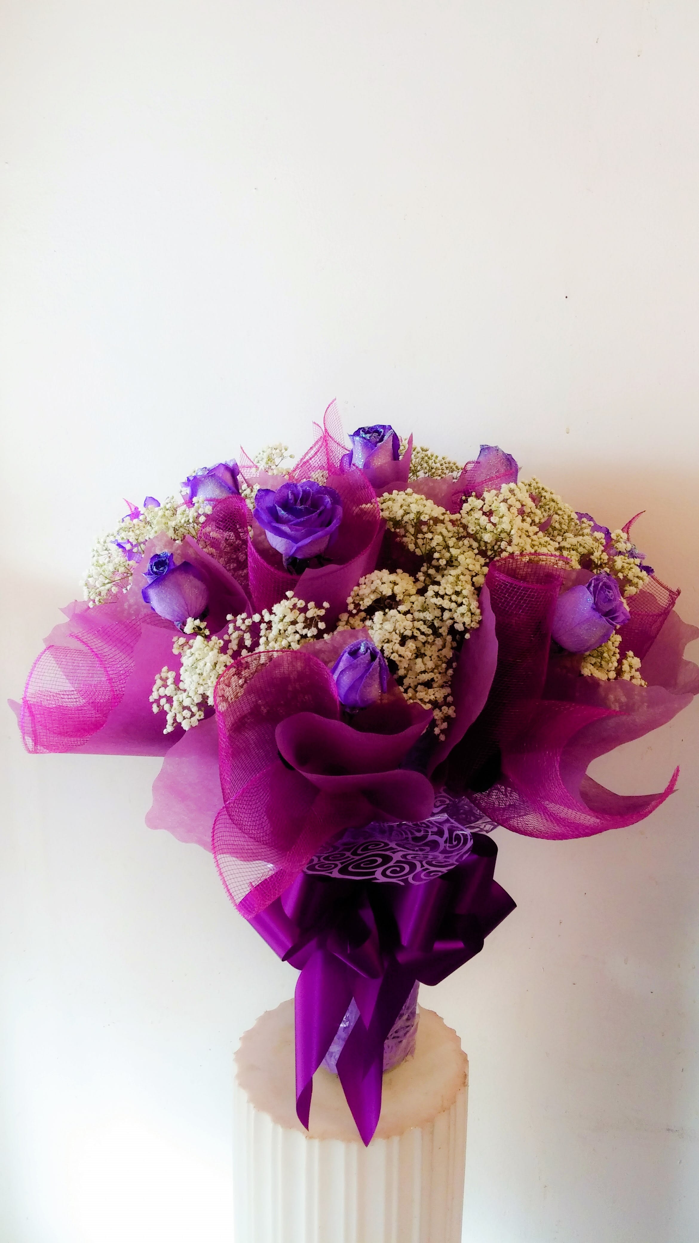 Hong Kong Style-1 Dozen Purple Roses Hong Kong Style-1 Dozen Purple Roses - 1 dozen glittered, dyed purple roses wrapped Hong Kong style, and elegantly arranged in a vase.