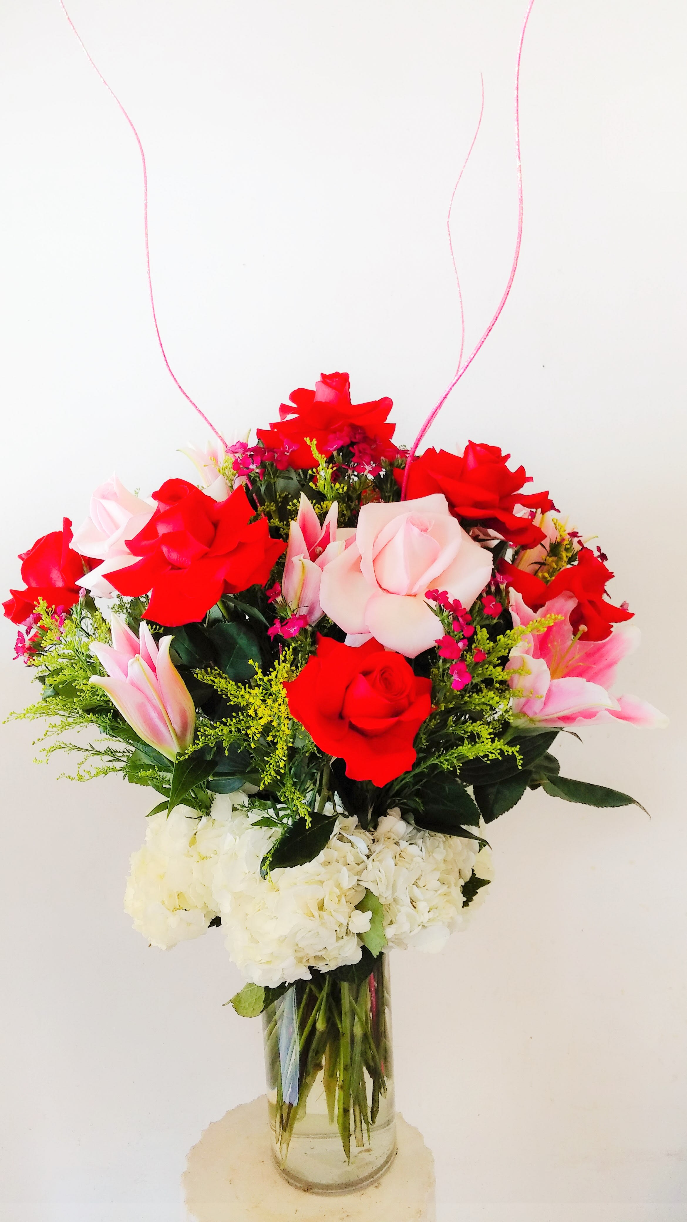 Mixed Floral-Roses, Lilies, Hydrangeas - Elegant arrangement consisting of roses, lilies, and hydrangeas, arranged in a 5&quot; x 12&quot; cylinder vase.