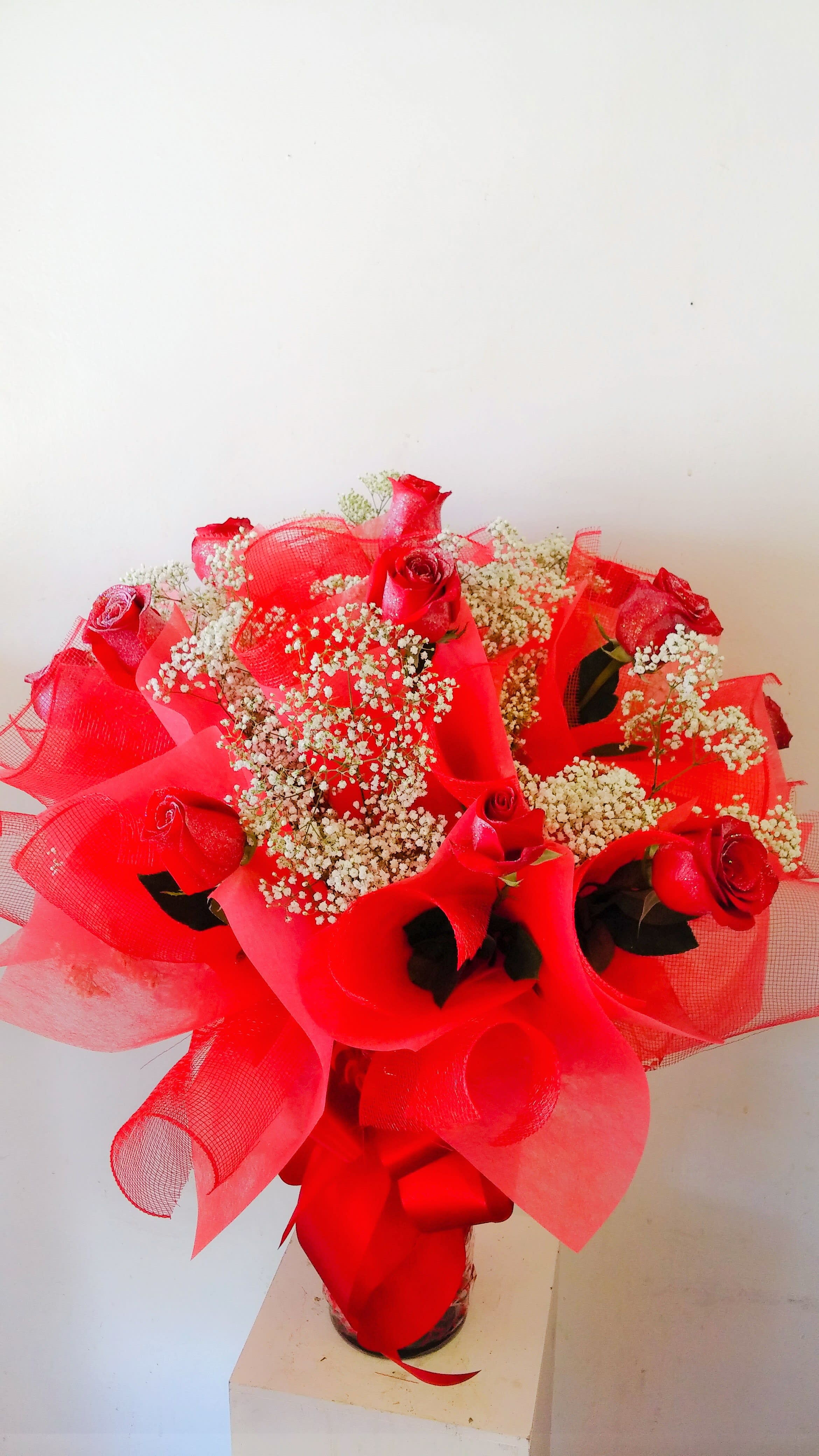 Hong Kong Style Arrangement Hong Kong Style Arrangement - 1 dozen glittered roses wrapped Hong Kong style and arranged in a vase