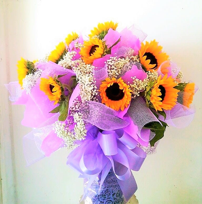 1 Dozen Sunflowers Hong Kong Style - 1 dozen sunflowers wrapped Hong Kong style, and elegantly arranged in a vase.