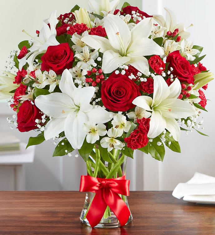 Fields of Europe® Bliss - That feeling of bliss, captured in a bouquet. Inspired by the beauty of the European countryside, our best seller brings together radiant roses and lush lilies in a glass vase wrapped in red ribbon.   *****Please read- Our florists always put their passion and creativity into each gift. At times, they may need to make substitutions to floral arrangements, including glassware and special vases to ensure your order is fresh and delivered in a timely manner. This is especially true as we navigate the evolving health crisis. Please know that in this instance, the utmost care and attention is given to ensure your gift is of equal value.  