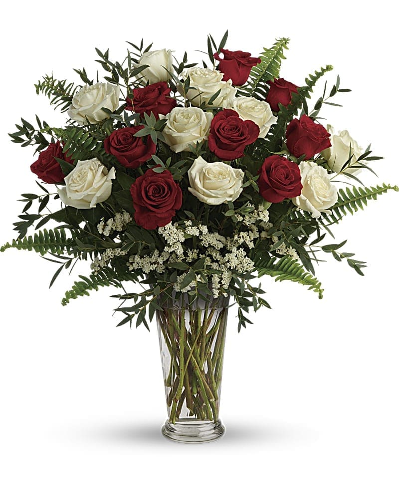 Yours Truly Bouquet - Make your special someone feel truly loved by surprising them with this extraordinary bouquet! A dozen and a half red and white roses are artfully arranged in a classic vase with delicate greens. This bouquet includes red roses white roses white sinuata statice parvifolia eucalyptus and sword fern. Delivered in a clear romanesque vase.